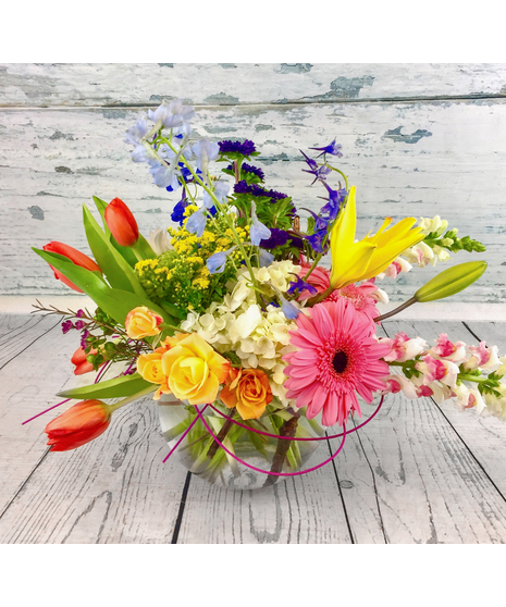 Assortment of lilies, tulips, and more in a bubble bowl vase